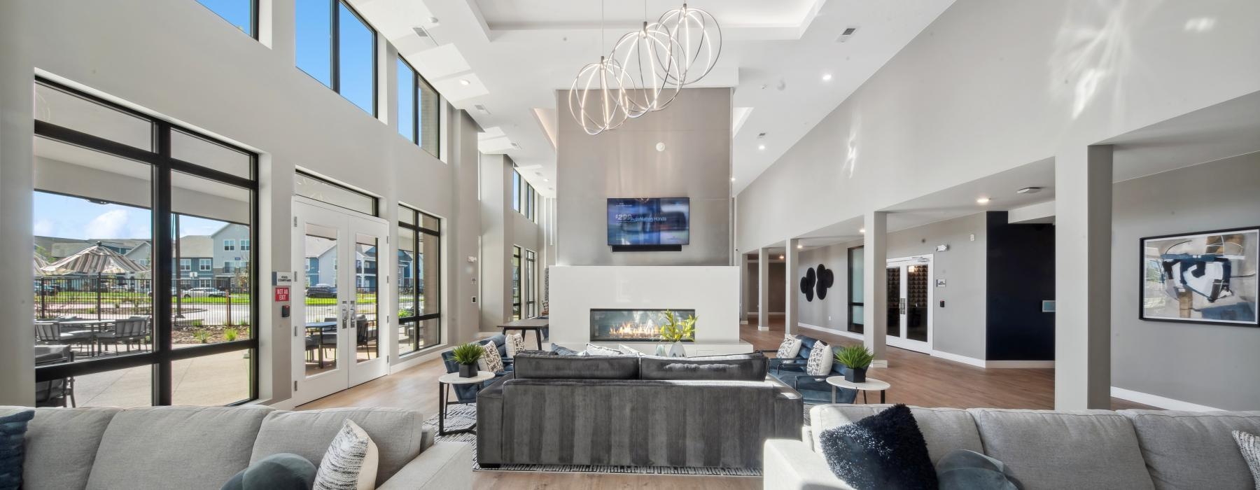 a spacious lounge with a large fire place at Ascend at Pena Station