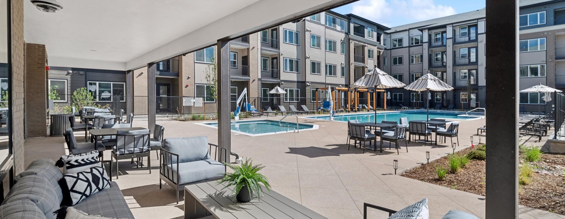a covered poolside lounge area at Ascend at Pena Station
