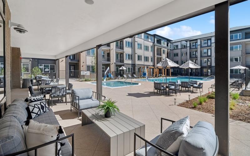 a poolside covered lounge area at Ascend at Pena Station